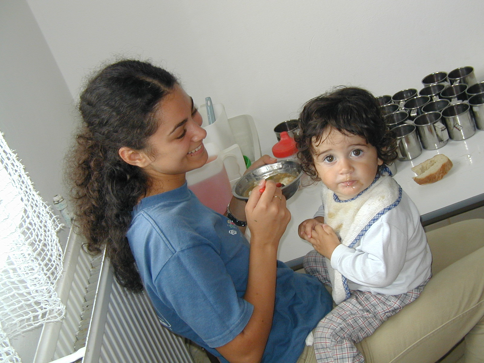 A caregiver feeding one of the children at Bistritia.